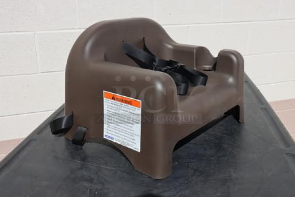 BRAND NEW Carlisle 911401 brown polypropylene booster seat with safety strap. Features warning label for safety instructions.
