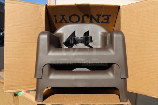 Brand new Carlisle 911401 brown polypropylene booster seat with safety strap, displayed in original packaging.