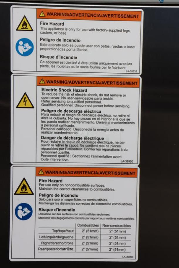 Warning labels on Alto-Shaam Vector F Series VMC-F3E Multi-Cook Oven. Fire and electric shock hazards detailed.