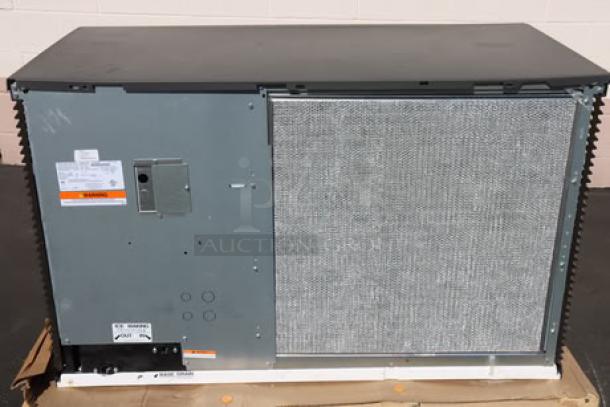 Manitowoc IDT1500A 48" air-cooled cube ice machine, brand new with minor dents. Model details and serial number visible.