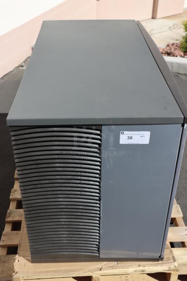 Brand new Manitowoc IDT1500A air-cooled cube ice machine, 48", 1668 lb capacity, with scratch-n-dent marks. Tags show S/N: 1121252692.