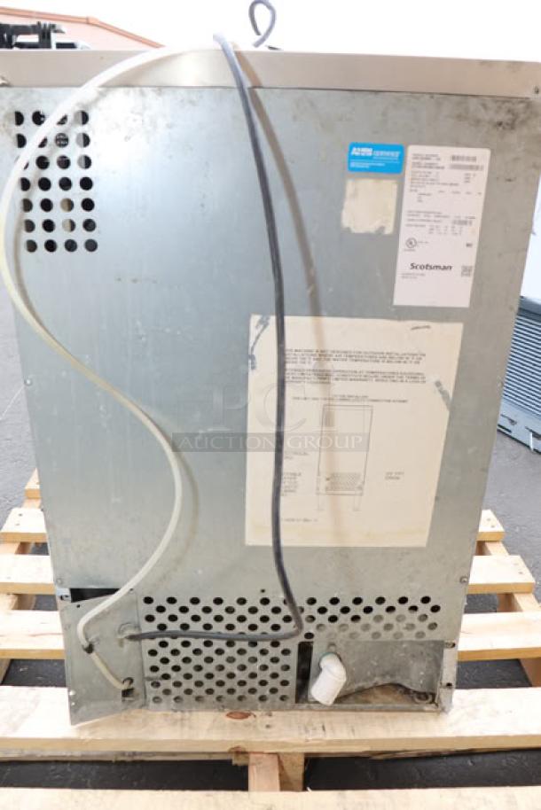 Brand new Scotsman UN1520A-1A air-cooled undercounter nugget ice machine, scratch-n-dent, 57 lb bin, tags show model and serial number.