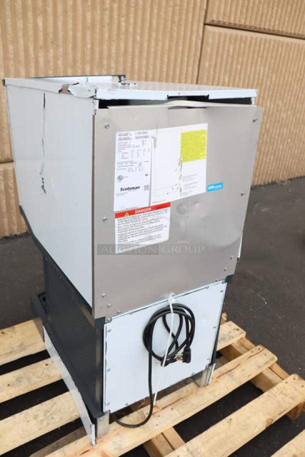 Brand new Scotsman UN1520AX-1 undercounter nugget ice machine, 57 lb. bin, 115V, 1 phase. Scratch-n-dent condition. Labels visible.