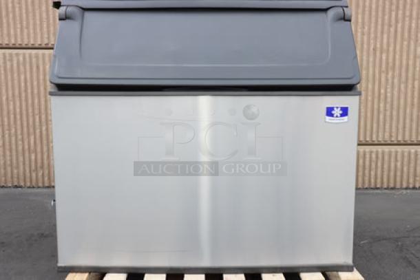 Brand new Manitowoc D970 ice storage bin, 882 lb capacity. Scratch-n-dent model, stainless steel exterior, visible logo.
