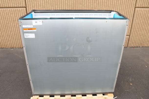 Brand new Manitowoc D970 Ice Storage Bin, 882 lb capacity, visible scratches, serial number 1121219180, on a pallet.