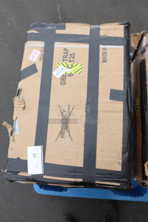 Brand new Regency 600GT25 grease trap in damaged packaging; visible scratches and dents; 50 lb, 25 GPM, non-threaded.