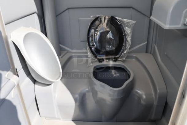 Brand new PolyJohn PJN3-1005 pewter portable restroom, assembled with translucent top. Interior features protective seat cover.