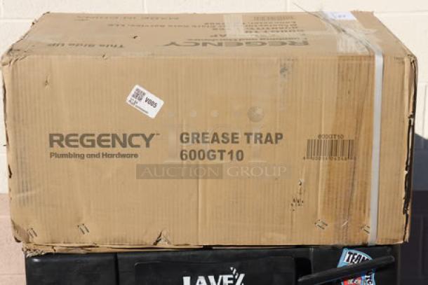 BRAND! Regency 600GT10 grease trap in damaged packaging; box shows scratching and denting. PDI certified, 20 lb., 10 GPM.