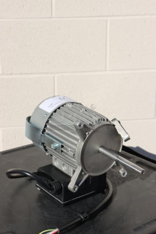 Brand new Blodgett 56966 blower motor, out of original packaging, showing metal fan casing and visible wires.