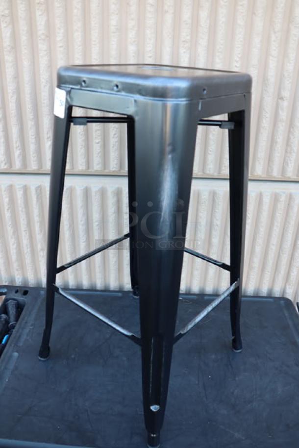 Lancaster Table & Seating onyx black outdoor backless barstool, model 164BNBKLSBLK, minor scratches and dents visible.
