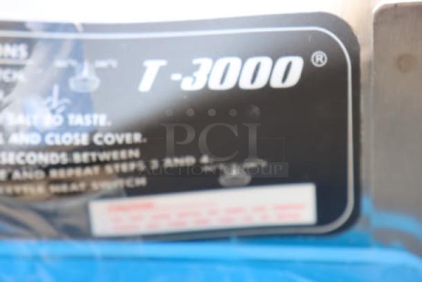 Cretors T-3000 Popcorn Popper label showing model T-3000 branding. Condition: Dented on top backside.