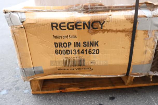 Cardboard box labeled "Regency Tables and Sinks Drop-In Sink 600D13141620," showing signs of water damage.