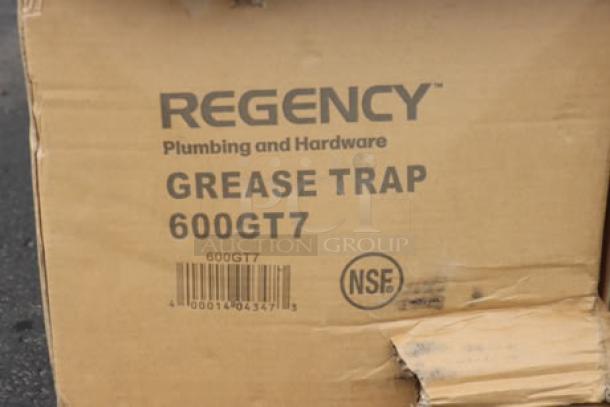 Cardboard box labeled "Regency Grease Trap 600GT7," showing possible water damage on edges.