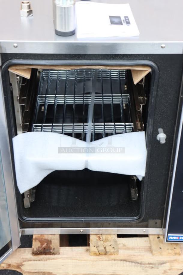 Brand new Moffat E33D5-P Turbofan half-size electric convection oven with steam injection, showing open door and racks.