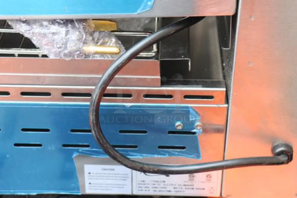 Brand new Avantco SAL23M 23" electric salamander with visible scratches and dents. Cord and safety labels shown.