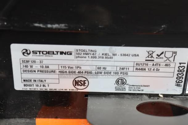 Label showing Stoelting SCBF128-37 model details, 115V, 2.6-gallon capacity, made in Italy, and safety certifications.