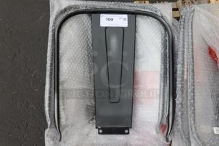 Brand new Lancaster Table & Seating metal chair backrest in black, shown in packaging. Auction label with bid info present.