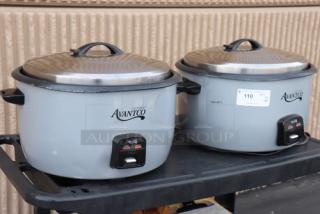 Brand new Avantco RCB124 electric rice cookers, 124-cup capacity. Two units on a cart. Each features a removable lid.