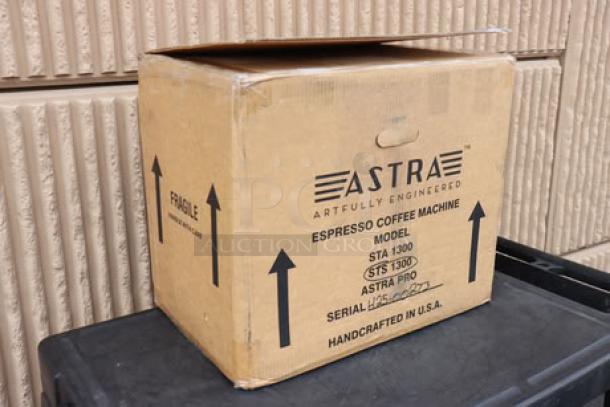 Brand new Astra STS1300 Pro semi-automatic steamer in original box. Model and fragile labels visible. Serial information blank.