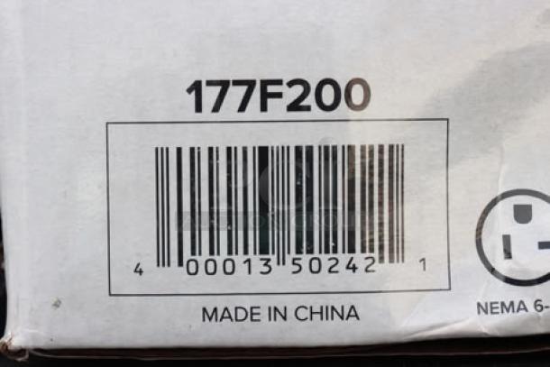 Barcode and labels on damaged packaging for Avantco F200 15 lb. Medium-Duty Electric Countertop Fryer, 208-240V.