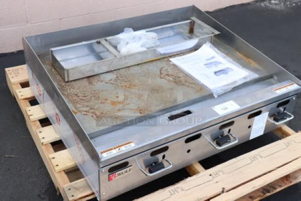 BRAND NEW Wolf Vulcan AGM36-NAT 36" gas griddle, 81,000 BTU, surface rust visible, on pallet, manual controls shown.