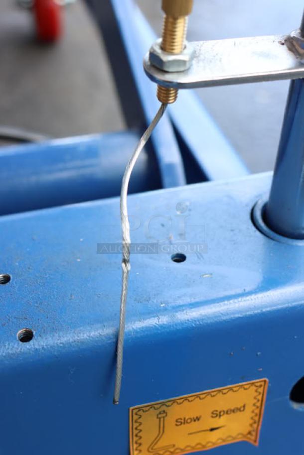 Alt text: Vestil CART-800-D-TS hydraulic elevating cart with a damaged cable. "Slow Speed" label visible on blue frame.