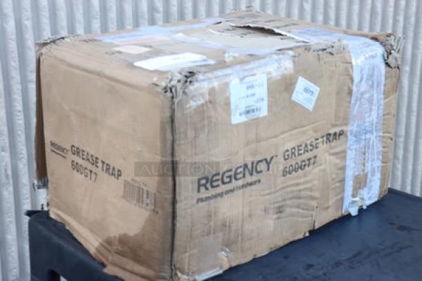BRAND NEW Regency 14 lb. 7 GPM Grease Trap, model 600GT7, in damaged original packaging, signs of scratching and denting.