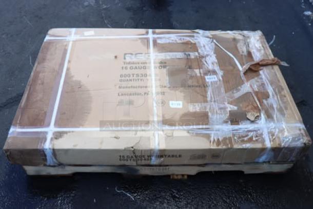 Regency 600TS3048S commercial work table in damaged packaging, showing possible scratches and dents. 30"x48" stainless steel.