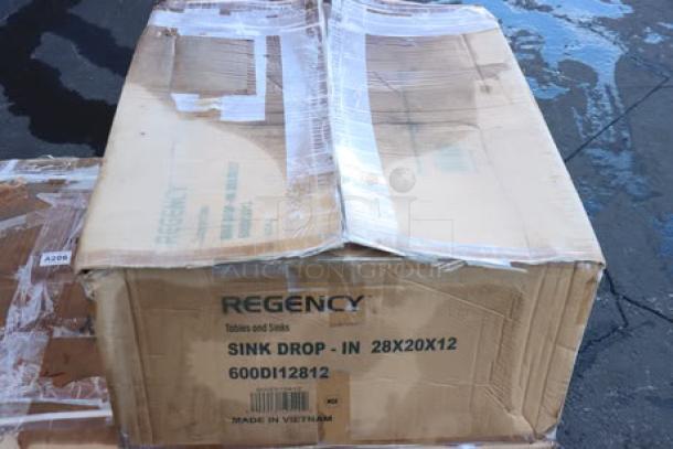 Regency 600DI12812 stainless steel drop-in sink in damaged packaging with possible scratches and dents.