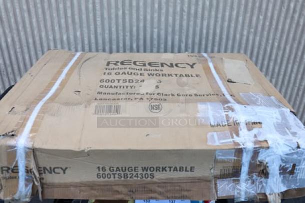 Regency 600TSB2430S 24" x 30" stainless steel work table in damaged packaging; features 4" backsplash, undershelf.
