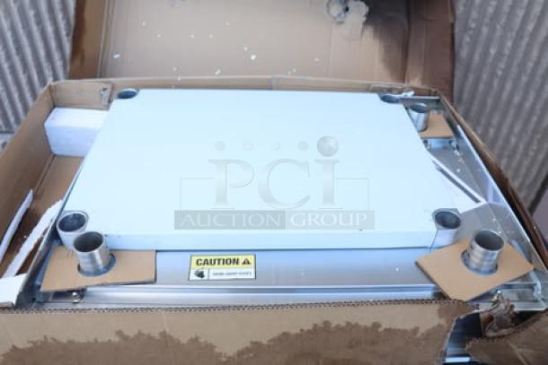 Regency 600TSB2430S stainless steel work table, 24"x30", with 4" backsplash and undershelf. Original packaging damaged.