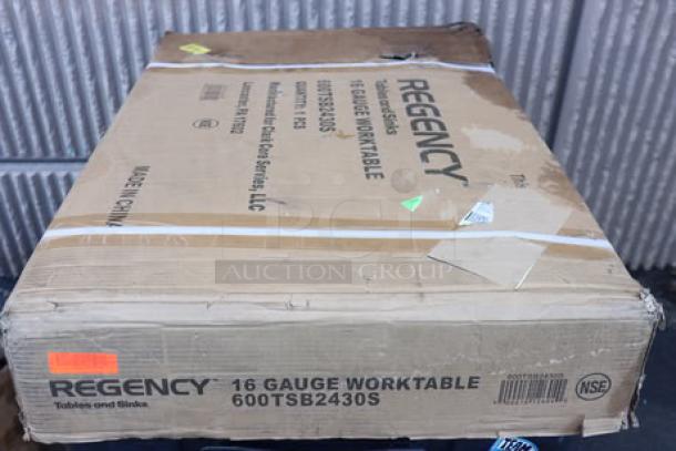 Regency 600TSB2430S 24"x30" stainless steel work table in damaged packaging; may have scratches/dents; includes 4" backsplash.