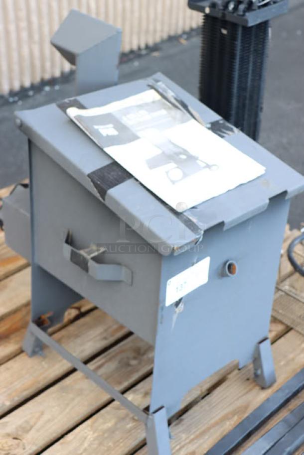 Steel liquid propane outdoor deep fryer with mobile stand on pallet. Brand new, out of packaging, may miss parts.