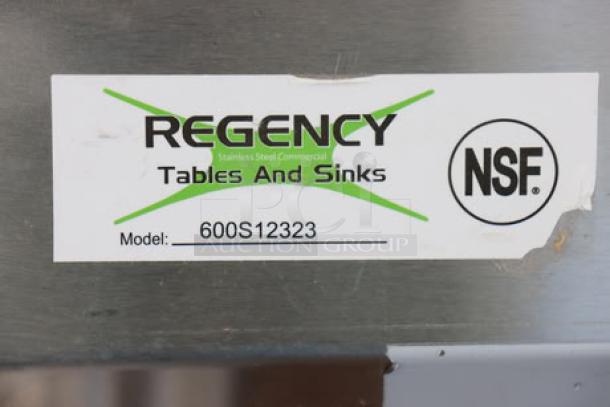"Regency 600S12323 label on stainless steel, NSF certified, indicating make and model of commercial sink."
