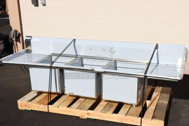Regency 600S31824218 three-compartment stainless steel sink with drainboards, 94", minor scratches/dents, on wooden pallet.