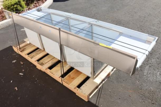 Regency 94" stainless steel three-compartment commercial sink, model 600S31824218, with 2 drainboards. New condition, slight scratches/dents.