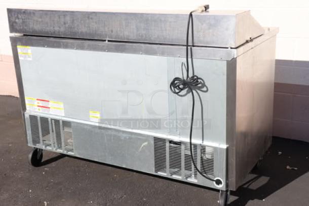 Beverage-Air SPED60HC-16-2 60" prep table, stainless steel, one door, two drawers, scratches visible, on casters.