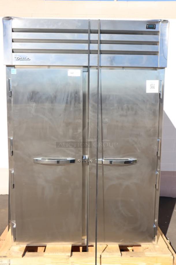 Brand new True STG2R-2S-HC refrigerator, dual solid doors, heavy-duty PVC shelves, on commercial casters. Scratch-n-dent condition.