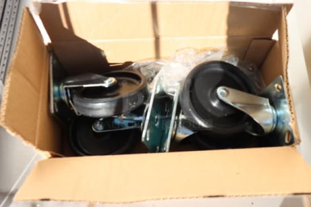 Box of heavy-duty commercial casters for True STG2R-2S-HC refrigerator, new condition, includes mounting hardware.