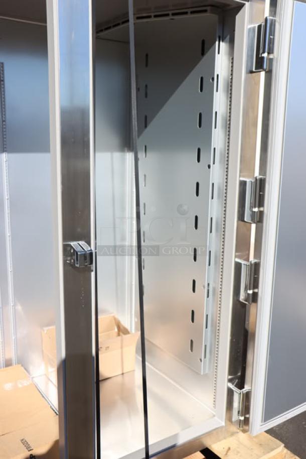True STG2R-2S-HC reach-in refrigerator with solid doors, heavy-duty PVC-coated wire shelves, and commercial casters, brand new condition with minor scratches. Serial: 11140377.