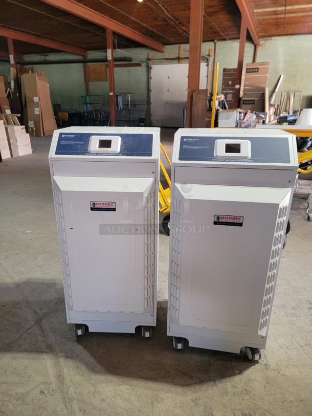 Abatement Technologies HC800FUV air purifiers, medical-grade, portable, on wheels, in warehouse setting.