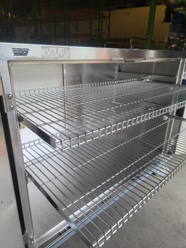 Heavy-duty stainless steel mobile cabinet by Suburban Surgical Co., Tote-AL Type C, features wire racks, durable, pristine condition.