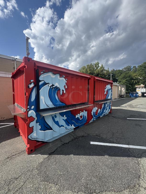 Custom 20' mobile beach bar container with wave murals, flip-up doors, bar equipment, and plumbing. Turn-key setup.