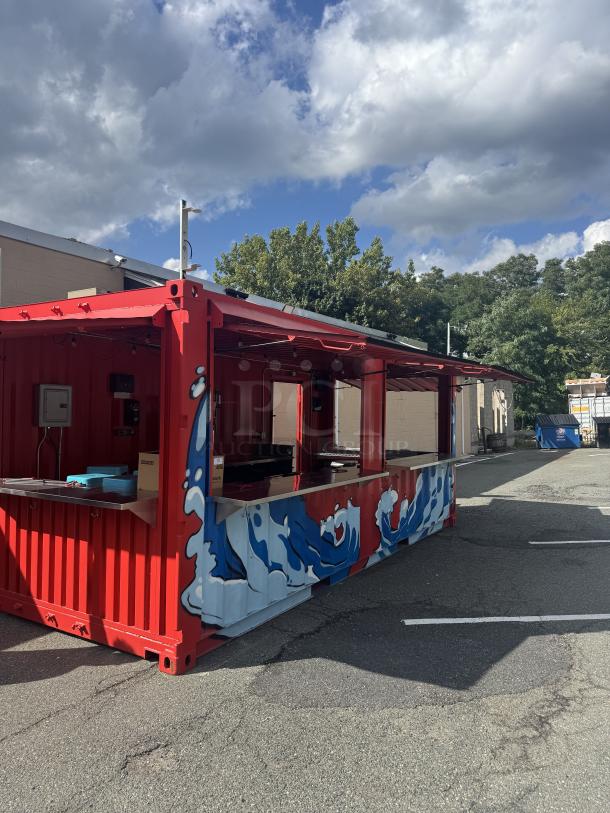 Custom 20' mobile beach bar container with blue wave murals, flip-up doors, and high-end bar equipment; perfect for events.
