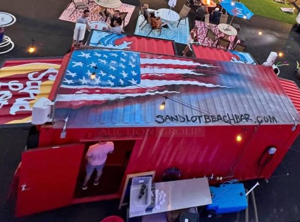 Custom 20' mobile beach bar container with wave artwork, flip-up service counters, and high-end bar equipment.