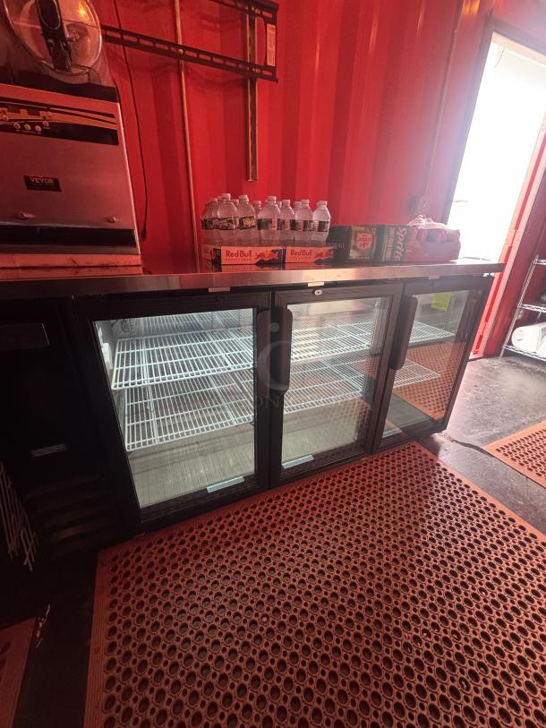 Fully equipped 20' mobile beach bar interior with 3-door cooler, VEVOR frozen drink machine, and beverage supplies.