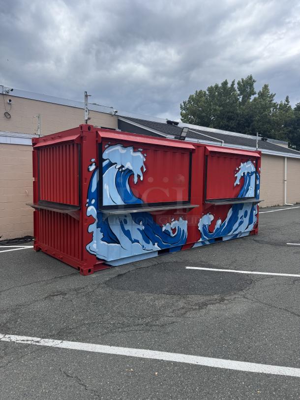 Custom 20' mobile beach bar container with blue wave murals. Features flip-up doors, beer coolers, frozen drink machine, sinks, and sound system.