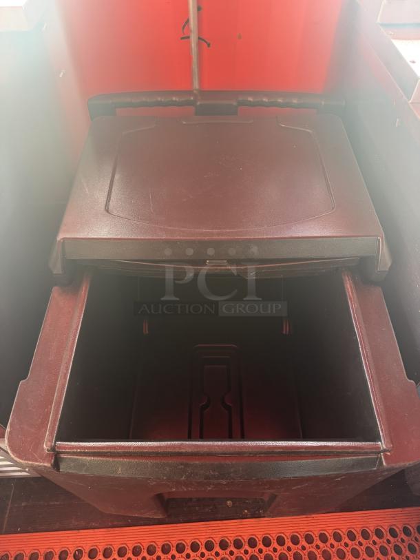 Open storage compartment inside the custom "Sandlot Beach Bar" container, featuring a durable lid and red interior accents.