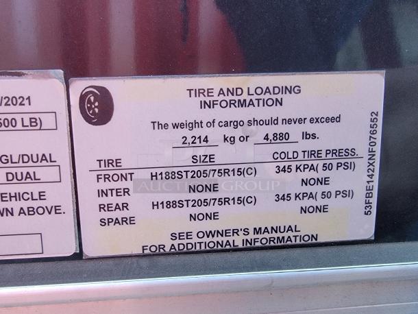 Tire and loading information label on a 2021 Covered Wagon mobile food trailer detailing weight limits and tire specifications. VIN# 53FBE142XNF076552.