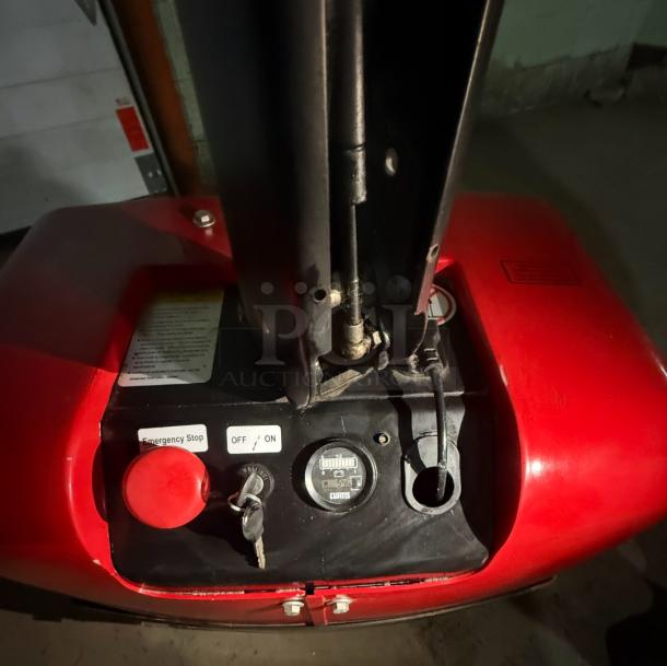 Dayton 55PD64 electric pallet jack control panel, showing emergency stop, key switch, and battery gauge; requires repair.